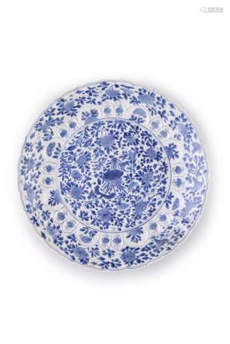 A BLUE AND WHITE LOTUS DISH, KANGXI (1662-1722) of circular form with barbed rim, moulded with