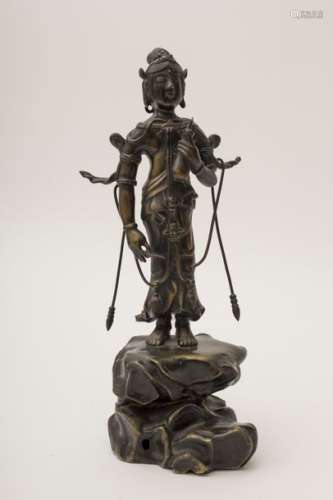Bronze Guanyin Standing on a rock and holding a b...