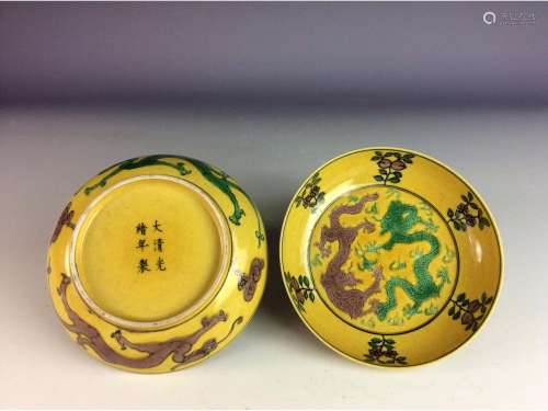 Pair of Chinese yellow glaze saucers, with twin dragons.
