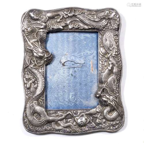White metal mirror Chinese, late 19th Century the shaped rectangular border in form of two dragons