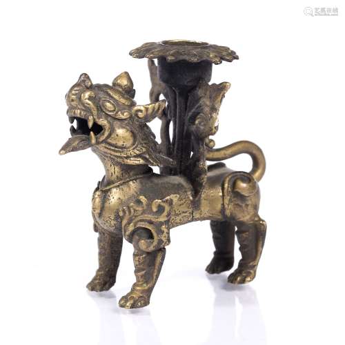 Candle holder Burmese, 19th Century supported by a temple dog 9cm across