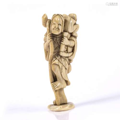 Ivory netsuke Japanese, Kyoto 18th Century a standing sennin holding a staff and hand scythe while