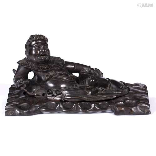 Carved hardwood recumbent figure possibly How Sien Sheng, Chinese, circa 1900 the figure holding