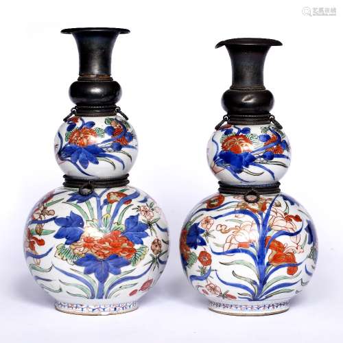 Pair of Imari vases Japanese, circa 1700 each with metal collar and neck, painted with flowering