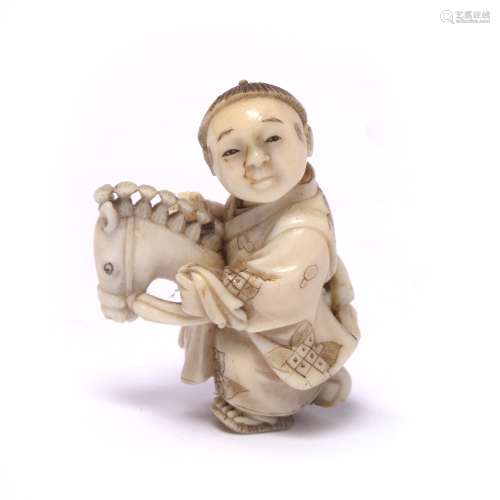 Ivory miniature netsuke of a boy Japanese, late Meiji child riding a hobby horse, robes engraved