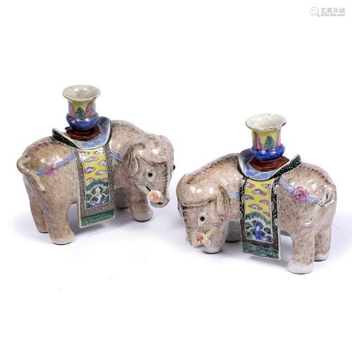 Pair of porcelain elephants Chinese, early 19th Century standing four square with candle holders and