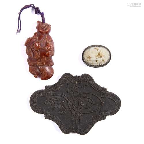 Opaque dark brown amber pendant Chinese, 19th Century carved as a child acolyte 4.5cm a miniature