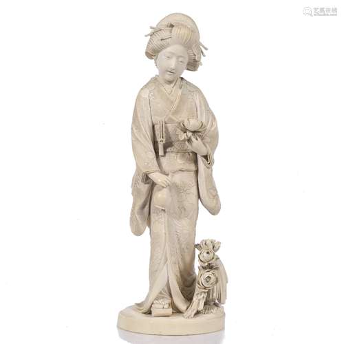 Ivory okimono Japanese, mid Meiji Geisha standing holding a bottle shaped vessel and a peony flower,