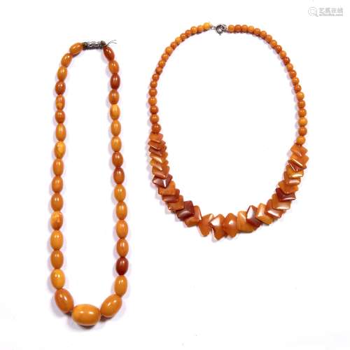 Two amber bead necklaces the first comprising a single strand of graduated amber beads 20mm to 10.