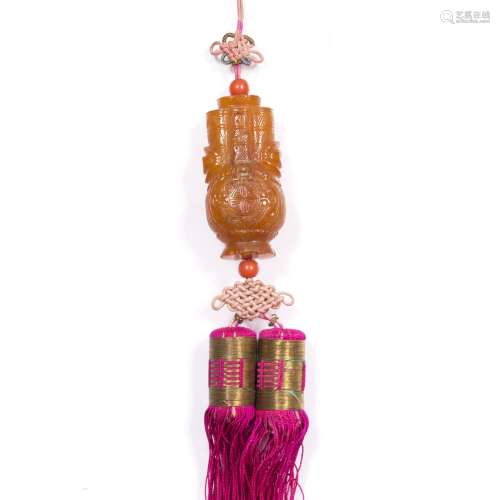 Carved amber pendant Chinese carved as a archaic vessel with long life symbol having a pink tassel