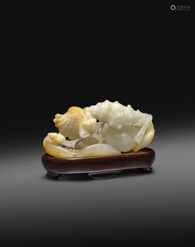 A RARE CHINESE WHITE JADE CARVING OF TWO BIRDS AMIDST SEA SHELLS