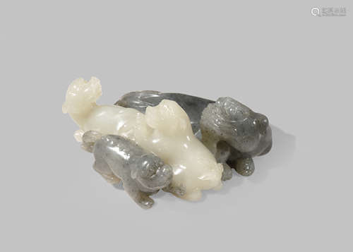 A CHINESE BLACK AND WHITE JADE GROUP OF LION DOGS