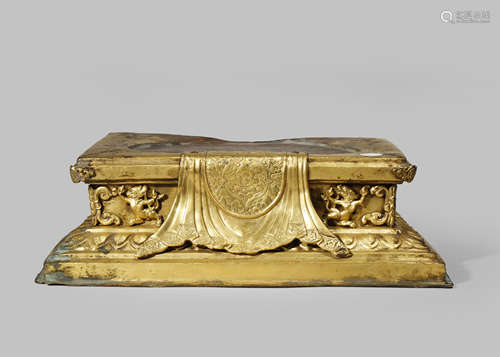 A TIBETAN GILT-COPPER RECTANGULAR BASE