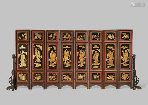 A CHINESE BLACK AND GOLD LACQUER EIGHT PANEL EROTIC SUBJECT TABLE SCREEN