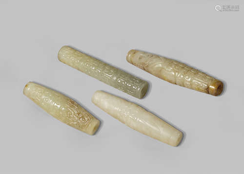 FOUR CHINESE CELADON JADE ARCHAISTIC CYLINDRICAL BEADS