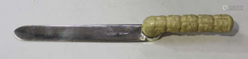 A late Victorian silver letter opener, fitted with a Japanese ivory handle, carved in relief with