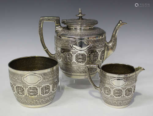 A Victorian Scottish silver three-piece tea set of circular form, decorated in relief with signs