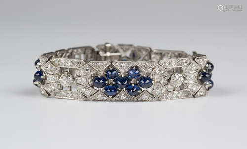 An Art Deco platinum, diamond and sapphire bracelet in a pierced geometric panel link design,