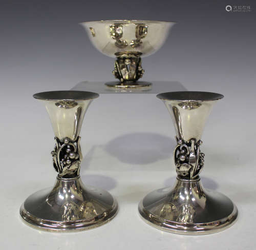 A pair of Danish sterling candlesticks and matching bowl, each hollow stem decorated with