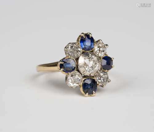 A gold, silver, sapphire and diamond nine stone cluster ring, mounted with the principal cushion