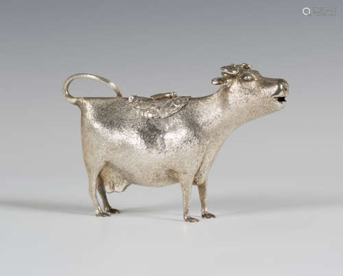 An Elizabeth II silver cow creamer, the tail curling to form the handle, the hinged cover with a fly