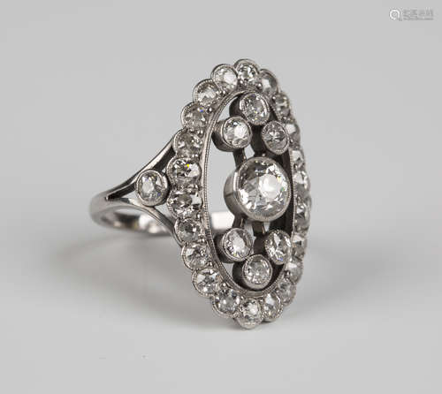 A white gold, platinum and diamond ring in a curved oval panel shaped openwork design, collet set