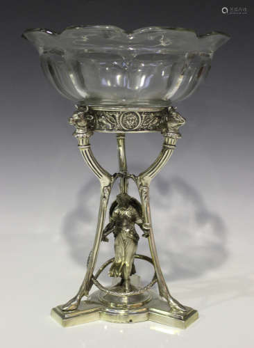 A Victorian silver table centrepiece, the circular top cast and pierced with masks, lions and