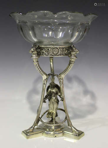 A Victorian silver table centrepiece, the circular top cast and pierced with masks, lions and