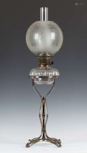 An Arts and Crafts plated brass table oil lamp by William Arthur Smith Benson, fitted with a cut