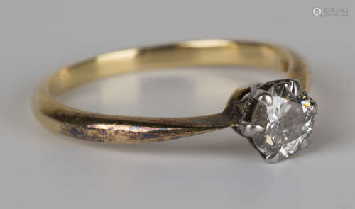 A gold and diamond single stone ring, claw set with a circular cut diamond, detailed '18ct', ring
