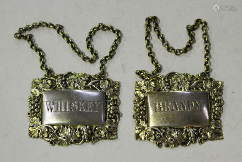 A pair of Victorian silver gilt decanter labels with embossed fruiting vine borders, engraved '