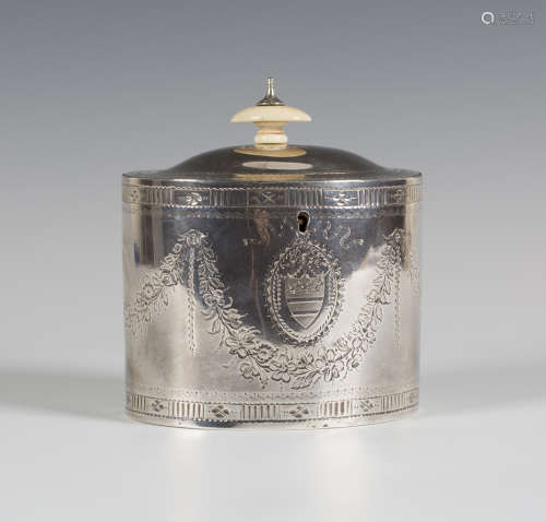 A George III silver oval tea caddy with hinged lid, engraved with floral and foliate garlands,