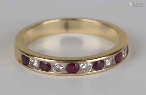 A gold, ruby and diamond eleven stone half-hoop eternity ring, indistinctly detailed '14K', ring
