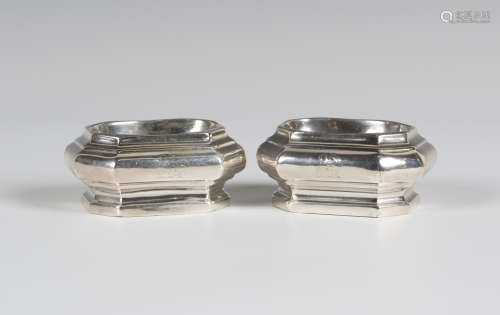 A pair of Queen Anne silver octagonal trencher salts, each with an oval aperture, London 1705 by