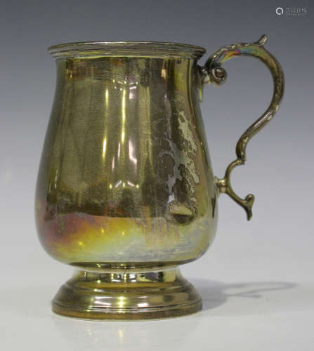 A George V silver tankard, the baluster body with foliate capped scroll handle, Chester 1911 by S.