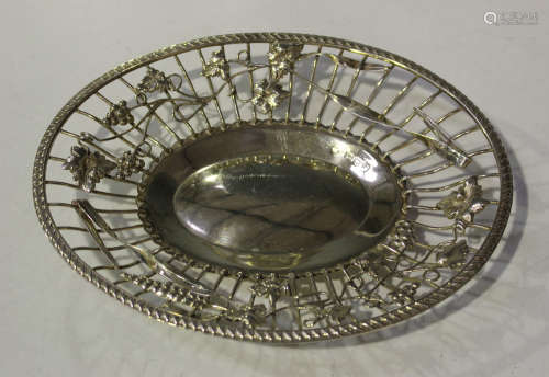 A late Victorian silver oval dish, the wirework sides applied with scrolling stems of fruiting vines