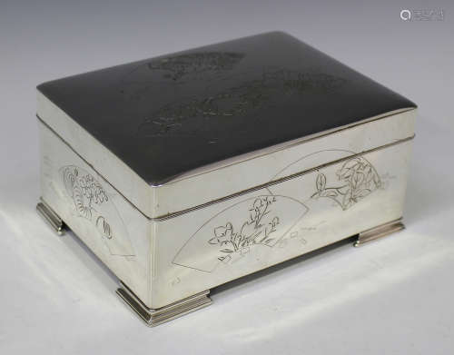 A Japanese silver rectangular musical jewellery box, the hinged lid and sides engraved with flower