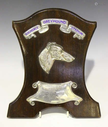 A George V silver mounted and oak shield shaped trophy plaque, the banner enamelled in blue with '