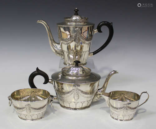 A Danish silver four-piece tea set of oval form, engraved and decorated in relief with floral