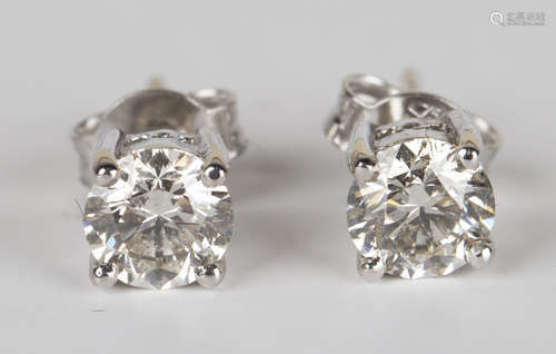 A pair of 18ct white gold and diamond single stone earstuds, each claw set with a circular cut