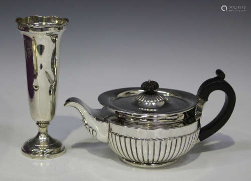 A late Victorian silver teapot of half-reeded form, London 1890 by Dobson & Sons, height 12cm,