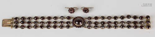 A 19th century gold and Bohemian garnet three row bracelet, the front mounted with a cluster set