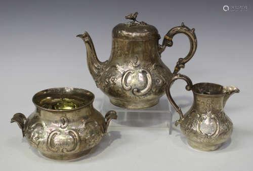 A Victorian silver bachelor's three-piece tea set of low-bellied form, decorated in relief with