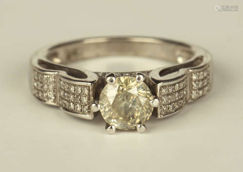 A white gold and diamond ring, claw set with the principal circular cut diamond between diamond