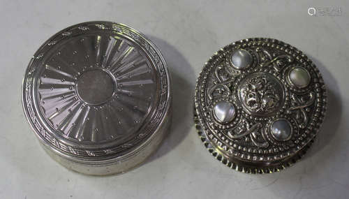 A late 19th/early 20th century German .800 silver circular box, the hinged lid inset with four