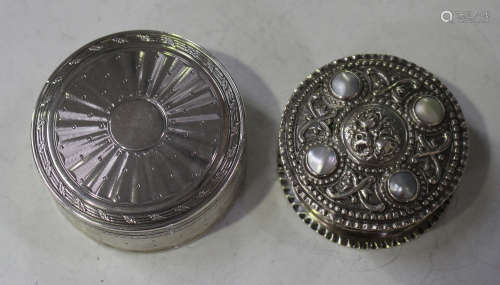 A late 19th/early 20th century German .800 silver circular box, the hinged lid inset with four