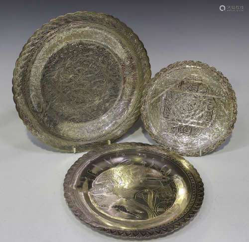 A group of three 20th century Egyptian silver circular dishes, each with engraved decoration,