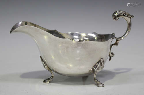 An Elizabeth II silver sauce boat with leaf capped flying scroll handle, on three cabriole legs