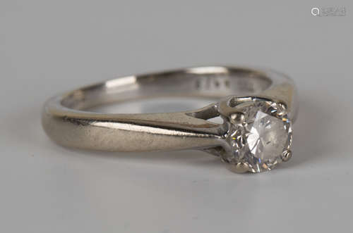 An 18ct white gold and diamond single stone ring, claw set with a circular cut diamond, detailed '.