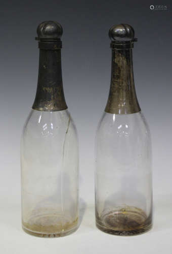 A pair of late Victorian silver mounted clear glass novelty decanters, each in the form of a